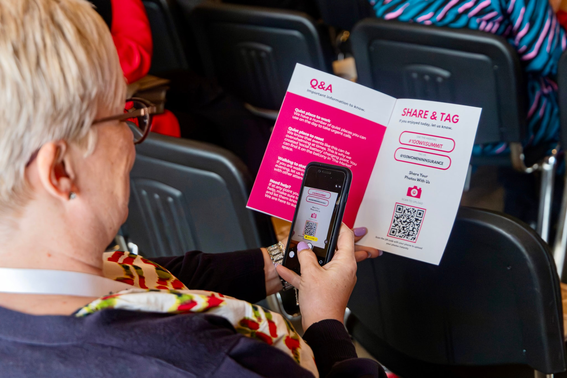 An attendee using the event programme